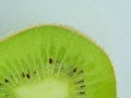 Fresh kiwi fruit slice in liquid with bubbles. Close-up of a kiwi fruit slice in soda water. Bubbles on kiwi fruit Royalty Free Stock Photo