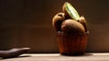 Fresh kiwi fruit in a wicker basket on a wooden background Royalty Free Stock Photo