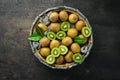 Fresh kiwi and green leaves in a wooden box on the old background. Fruits. Top view. Royalty Free Stock Photo