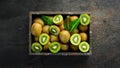 Fresh kiwi and green leaves in a wooden box on the old background. Fruits. Top view. Royalty Free Stock Photo