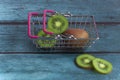 fresh kiwi in a grocery basket . Fruit shopping concept