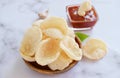Fresh Krupuk on bright background.Prawn Crackers or Shrimp Chips with ketchup and garlic,Close up view, bright mood