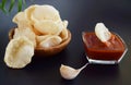 Fresh Krupuk on dark background.Prawn Crackers or Shrimp Chips with ketchup and garlic