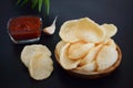 Fresh Krupuk on dark background.Prawn Crackers or Shrimp Chips with ketchup and garlic