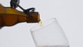 Beer pouring bottle glass in super slow motion closeup. Alcohol beverage flowing Royalty Free Stock Photo