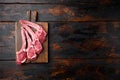 Fresh lamb rib chop, on old dark  wooden table background, top view flat lay, with copy space for text Royalty Free Stock Photo