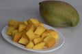 Fresh large totapuri mangoes sliced to small pieces, juicy and vibrant in color