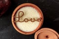 Fresh lassi in traditional indian clay pot and word Love