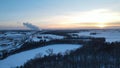 Winter Sunset with Snow Covering Fields, Trees, Roads, and Highway Royalty Free Stock Photo