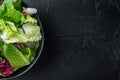 Fresh leaves of different lettuce salad, on black background, top view flat lay  with copy space for text Royalty Free Stock Photo