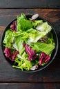 Fresh leaves of different lettuce salad, on old dark  wooden table background, top view flat lay Royalty Free Stock Photo