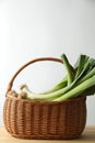Fresh leeks in basket on wooden table Royalty Free Stock Photo