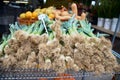 Fresh leeks on display at a farmers market or grocery store neatly folded on the table. Vegetable background. Fruit market.