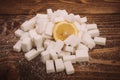 Fresh lemon on bunch of sugar cubes and granulated sugar Royalty Free Stock Photo