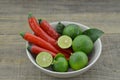 Fresh lemon with chili in bowl on wooden background Royalty Free Stock Photo