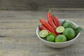 Fresh lemon cut half with chili in bowl on wooden background Royalty Free Stock Photo