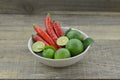 Fresh lemon cut half with chili in bowl on wooden background Royalty Free Stock Photo