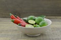 Fresh lemon cut half with chili in bowl on wooden background Royalty Free Stock Photo