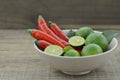 Fresh lemon cut half with chili in bowl on wooden table Royalty Free Stock Photo