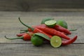 Fresh lemon cut half with chili on wooden background Royalty Free Stock Photo