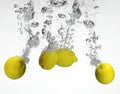 Fresh lemon dropped into water Royalty Free Stock Photo