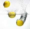 Fresh lemon dropped into water Royalty Free Stock Photo