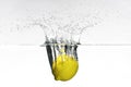 Fresh lemon dropped into water Royalty Free Stock Photo