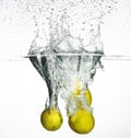 Fresh lemon dropped into water Royalty Free Stock Photo