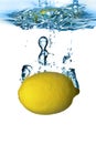 Fresh lemon dropped into water Royalty Free Stock Photo