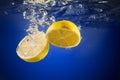 Fresh lemon dropped into water Royalty Free Stock Photo