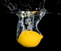 Fresh lemon dropping into water