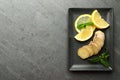 Fresh lemon, ginger and mint on grey table, top view. Space for text Royalty Free Stock Photo