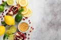 Fresh lemon, lime, pomegranate, dried tea rose flowers, tea, cane sugar, mint leaves and glass teapot on gray background. Ingredie Royalty Free Stock Photo