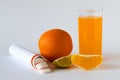 Fresh lemon and oranges, vitamin C pills in container isolated on white background. Royalty Free Stock Photo