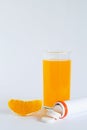 Fresh lemon and oranges, vitamin C pills in container isolated on white background. Royalty Free Stock Photo