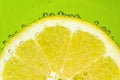 Fresh lemon in soda water covered with bubbles Royalty Free Stock Photo