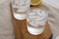 Fresh Lemon Sparkling Water with Ice on a rustic wooden board, low angle view