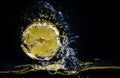 Fresh lemon splashing in water over black Royalty Free Stock Photo