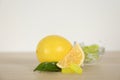 Fresh lemon and tasty small drops on wooden table