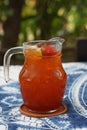 fresh lemon tea and ice in a glass jug placed on white and blue fabric, blur nature background, fruit, drink, health, banner, Royalty Free Stock Photo