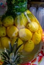 Fresh lemon water lemonade detox water in large vase glass during hotel brunch buffet in the garden