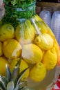 Fresh lemon water lemonade detox water in large vase glass during hotel brunch buffet in the garden