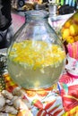 Fresh lemon water lemonade detox water in large vase glass during hotel brunch