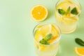 Fresh lemon water with mint leaves on a green background Royalty Free Stock Photo