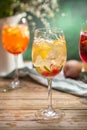 Fresh lemonade cocktail with orange, cherry and ice in wine glass splash on wooden table Royalty Free Stock Photo