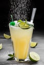 Fresh lemonade with mint, lime and ice in glass on dark background. Royalty Free Stock Photo