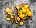 Fresh lemons in a basket with a knife on a cutting Board. Royalty Free Stock Photo