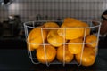 Fresh lemons. Basket of yellow lemons on cafe counter. Side view Royalty Free Stock Photo