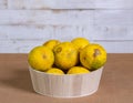 Fresh lemons in a bowl on a brown surface Royalty Free Stock Photo