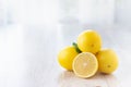 Fresh lemons on bright kitchen table. Royalty Free Stock Photo